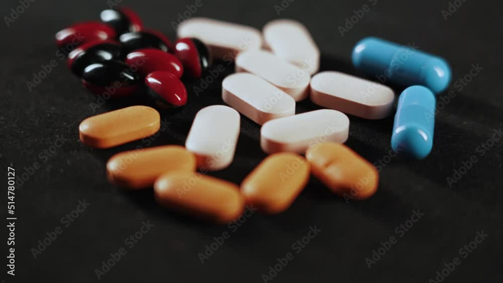 Pills Medical pills and capsules with light effect Isolated on a black background 4k Pills Medical pills and capsules with light effect Isolated on a black background 4k