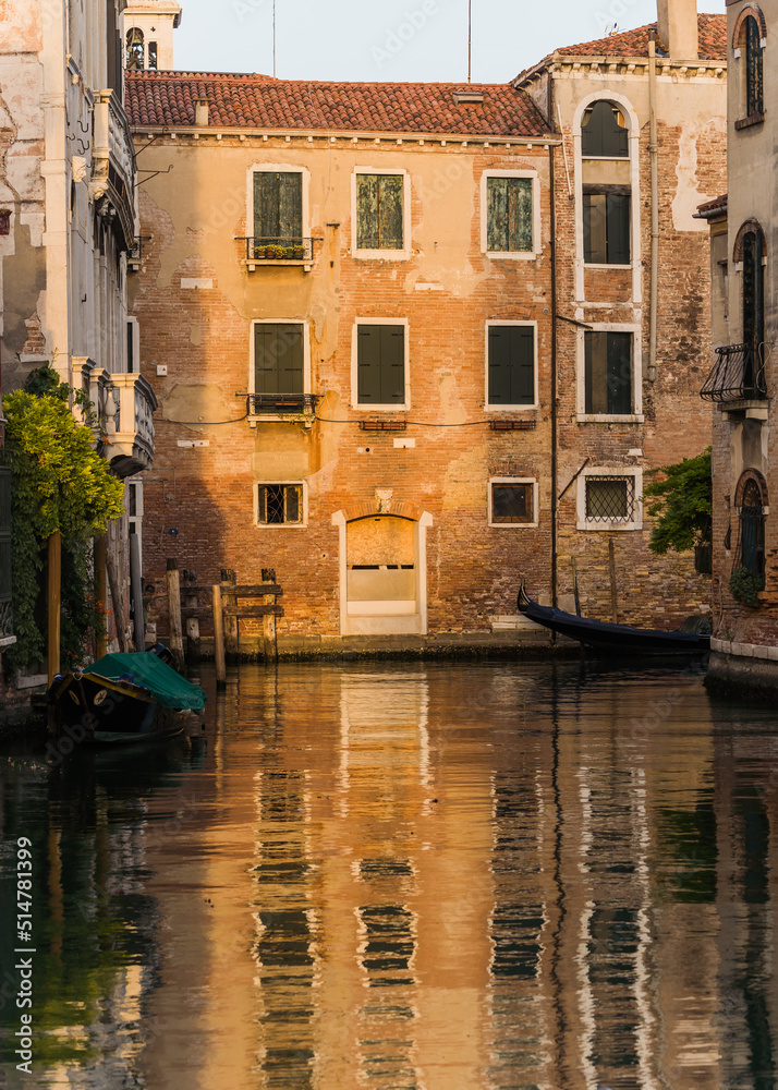 charming beautiful and calm canal with plants hanging over the wall in Venice, Italy 