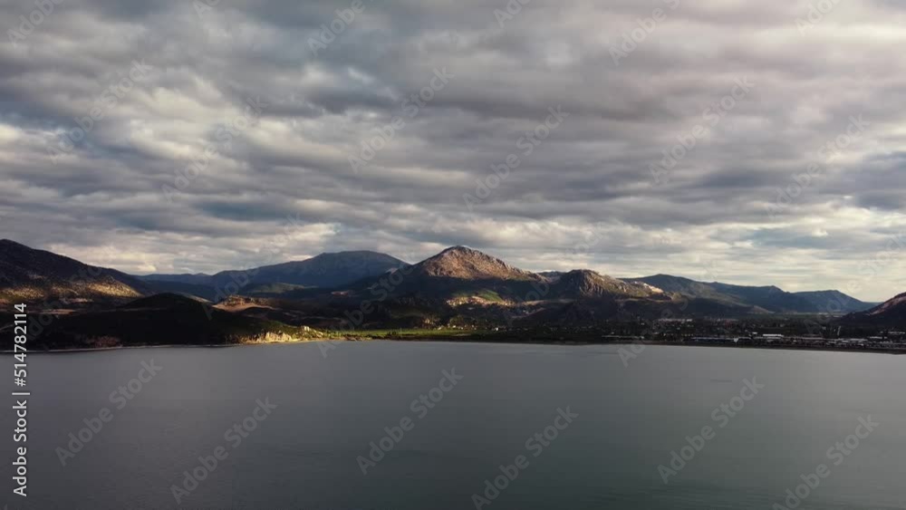 Tranquil scenery of Egirdir lake and mountain range on the shore next to small village filmed by drone at warm summer day. Landscape of an idyllic turkish nature. Travelling to popular touristic place Tranquil scenery of Egirdir lake and mountain range on the shore next to small village filmed by drone at warm summer day. Landscape of an idyllic turkish nature. Travelling to popular touristic place