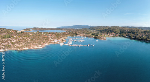 Sithonia Chalkidiki, Greece. Ormos Panagias bay and boat marina aerial drone view, sunny summer day.