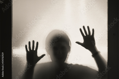 Shadowy figure behind glass - horror background