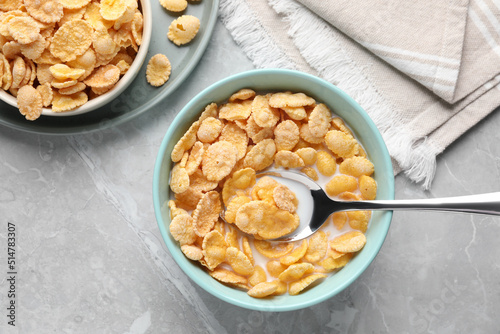 Obraz na płótnie Tasty cornflakes with milk served on light grey table, flat lay