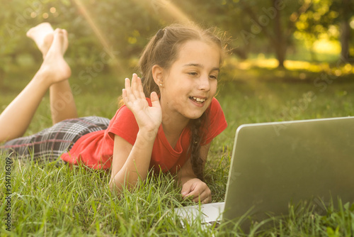 Kids using laptop learning in organic vegetable farmland in raral photo