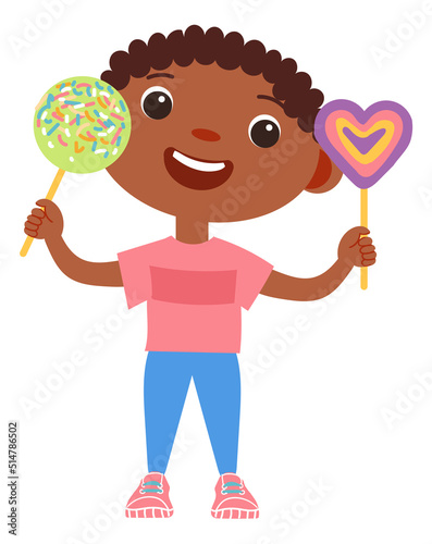 Cheerful boy holding lolipops. Happy child with caramel candy