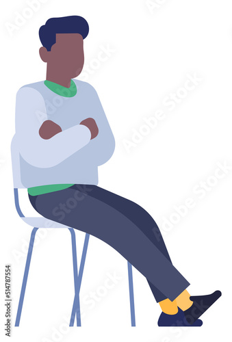 Man sitting on chair with crossed arms and legs