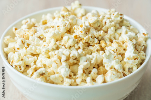 Selective focus. close up of popcorn in bowl on the wooden table.