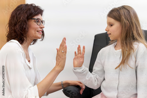 Patient and doctor high five in a clinic after a biofeedback session