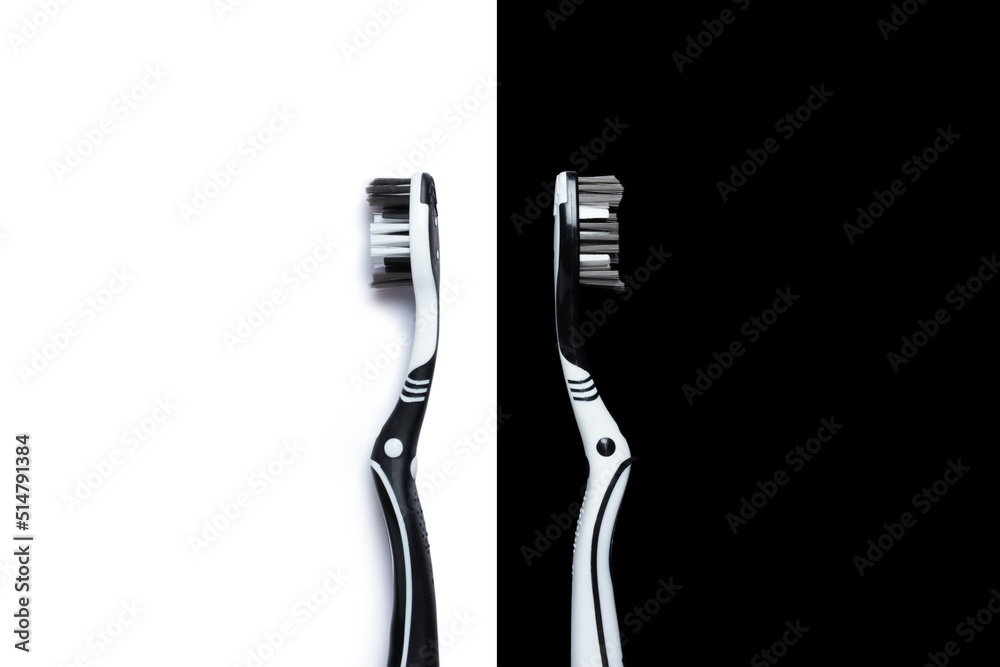 Two toothbrushes on a black and white background. The concept of oral hygiene, dental care, a collage of toothbrushes Two toothbrushes on a black and white background. The concept of oral hygiene, dental care, a collage of toothbrushes