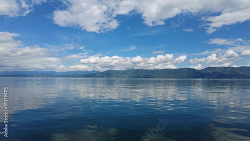 Beautiful dramatic summer cloudscape over Flathead Lake in Montana on calm June day 4K.