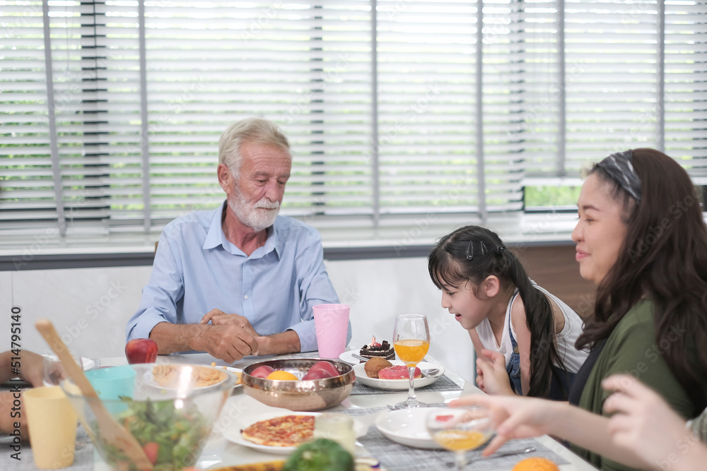 Happy multiracial family having dinner party In Kitchen Together - Group of friends dining at garden restaurant - Young people enjoying lunch break together - Food and beverage lifestyle concept. 