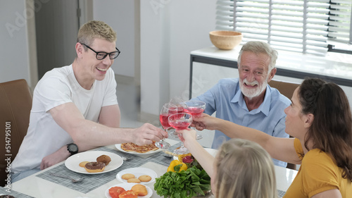 Happy multiracial family having dinner party In Kitchen Together - Group of friends dining at garden restaurant - Young people enjoying lunch break together - Food and beverage lifestyle concept. 