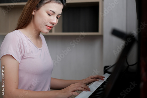 Portrait of beautiful woman playing piano. asian Young woman playing piano.