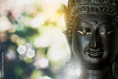face macro photo Buddha statue made of bronze ancient shape on  white light bokeh © chaophrayaart