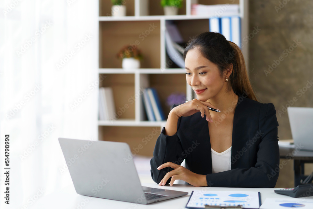 Asian businesswoman sitting happily working in the office Asian businesswoman sitting happily working in the office