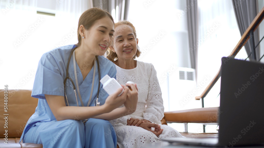 Asian doctor giving an advice and explaining to elder female patient.
