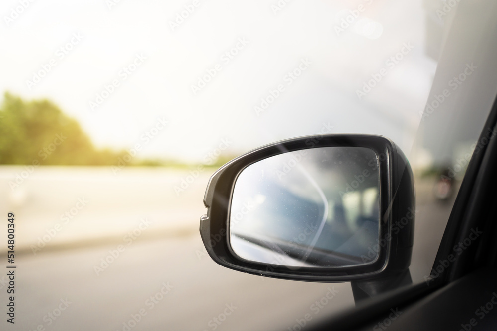 Vehicle side mirror while vehicle moving on the highway with copyspace. Safety driving concept. Vehicle side mirror while vehicle moving on the highway with copyspace. Safety driving concept.