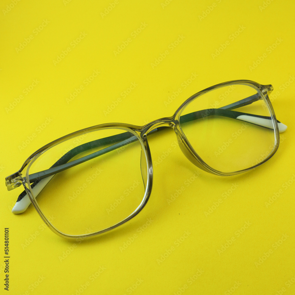 Clear eyeglasses on a yellow background Clear eyeglasses on a yellow background