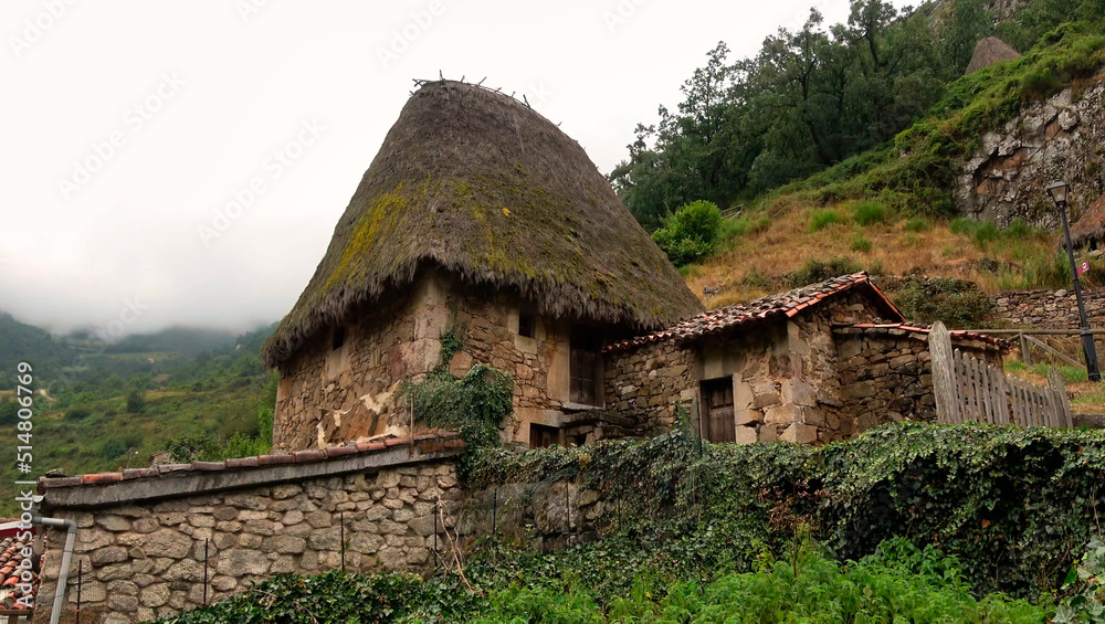 photographic image of old houses built with stones and plant materials, town in Asturias, in the middle of the vegetation. Spain photographic image of old houses built with stones and plant materials, town in Asturias, in the middle of the vegetation. Spain