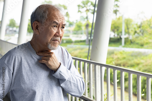 Old senior man having sorethroat photo