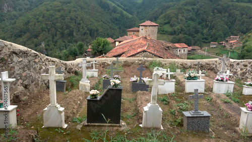 photographic image, cemetery in the middle of a town of old construction in a wooded area, Asturias. Spain photo