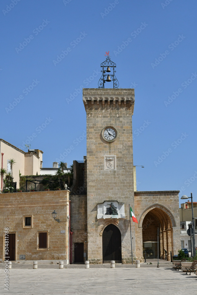 Fototapeta premium The bell tower of a church in the town square of Uggiano, a medieval village in the Puglia region of Italy.