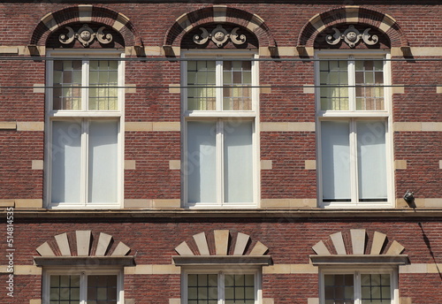 Amsterdam Nieuwezijds Voorburgwal Street Building Facade Close Up with Windows and Sculpted Details, Netherlands