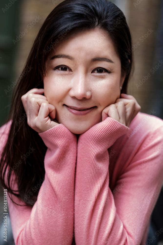 Portrait of mature korean woman looking at camera. Portrait of mature korean woman looking at camera.