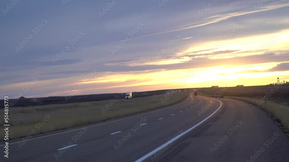 Cars and freight semi trucks loaded with goods driving along an empty highway, transporting cargo at morning dawn. Container truck delivery transporters hauling cargo at golden sunset Cars and freight semi trucks loaded with goods driving along an empty highway, transporting cargo at morning dawn. Container truck delivery transporters hauling cargo at golden sunset