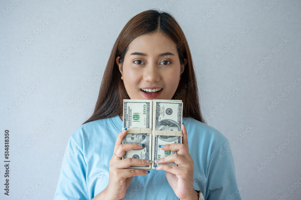 Asian woman face Happy holding a dollar bill, happy face, successful
Asian woman face Happy holding a dollar bill, happy face, successful