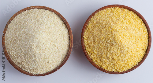 Nigerian yellow and white garri in a wooden bowl.