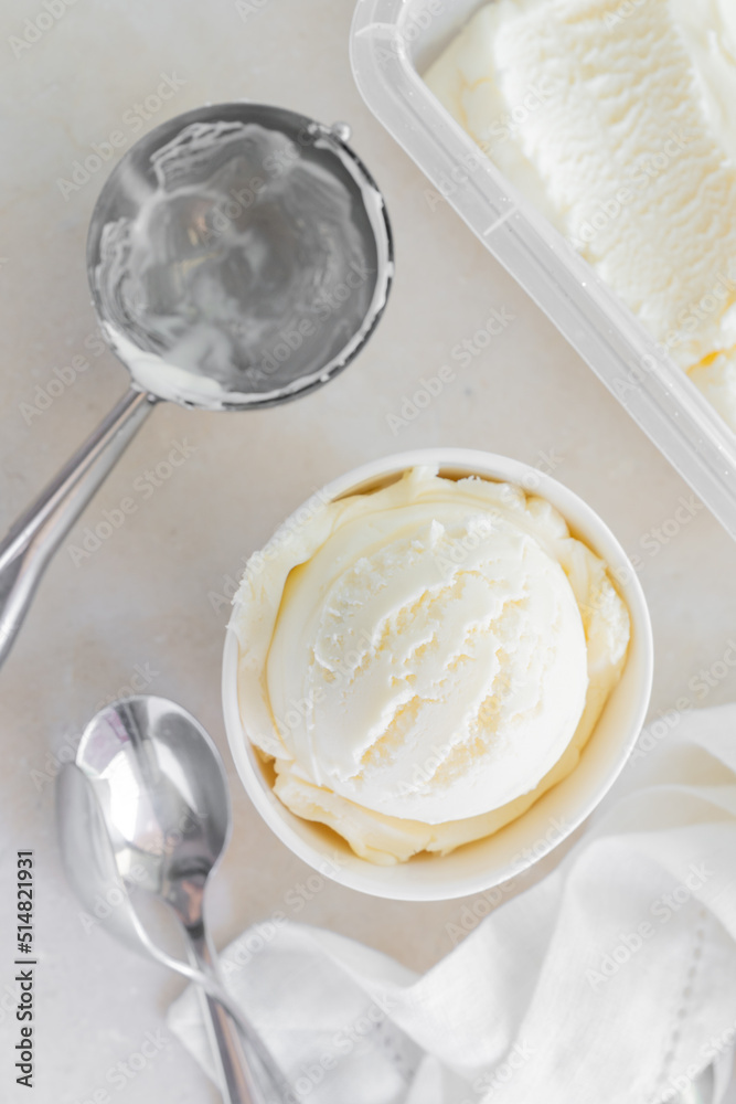 Vanilla ice cream in white cup, marble background Vanilla ice cream in white cup, marble background