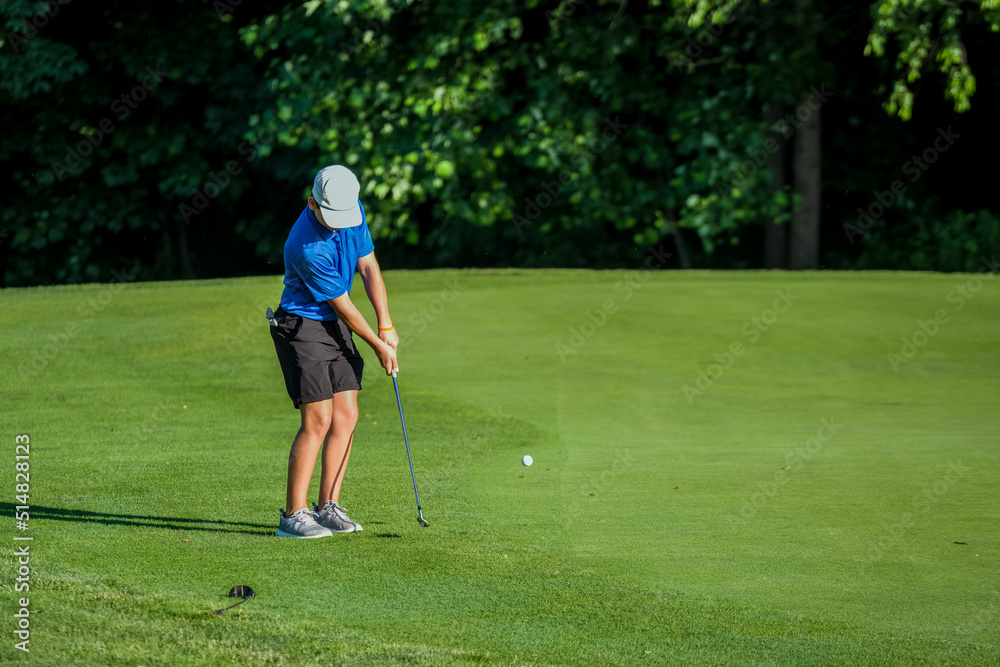 Fototapeta premium Junior golf on a beautiful day on the course