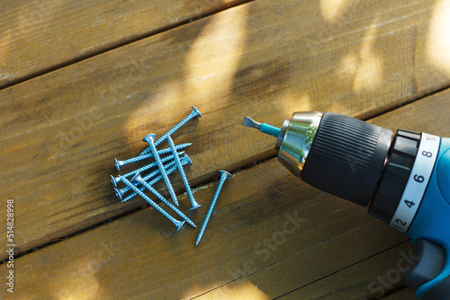 self-tapping screw and screwdriver on a wooden board