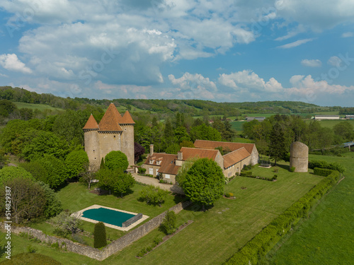 Aerial view of the Pancy castle in Angely Burgundy France with central keep protected by two circular towers, large outbuildings create a U-shaped wind around the courtyard standalone circular tower  photo