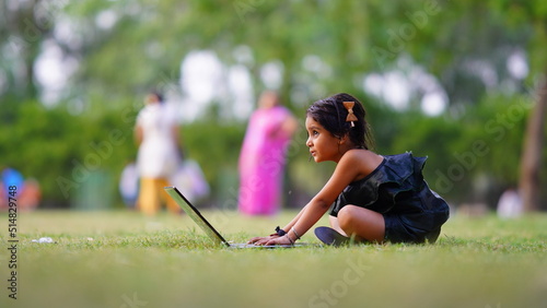 using laptop little girl in the farm with happy mood