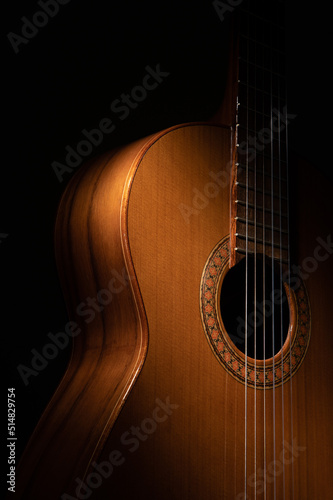Classical guitar close up on a black background 
