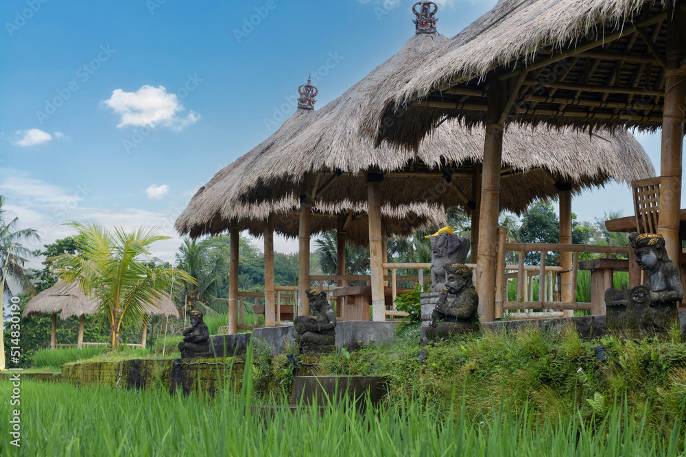 Three Balinese bamboo huts with straw roof Three Balinese bamboo huts with straw roof
