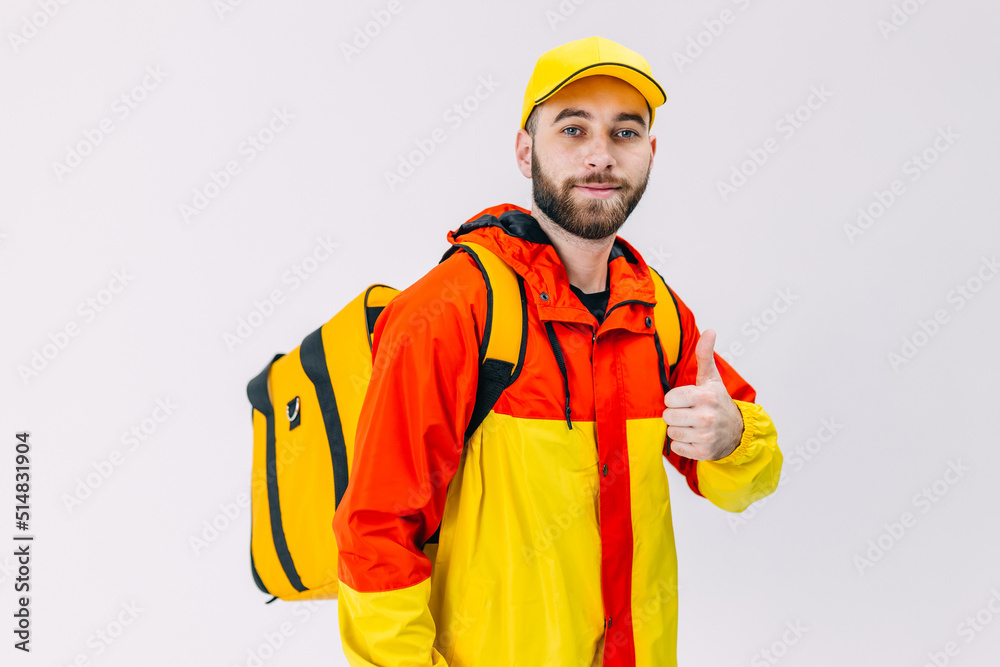 Smiling courier with thermal backpack smiles at the camera and s Smiling courier with thermal backpack smiles at the camera and s