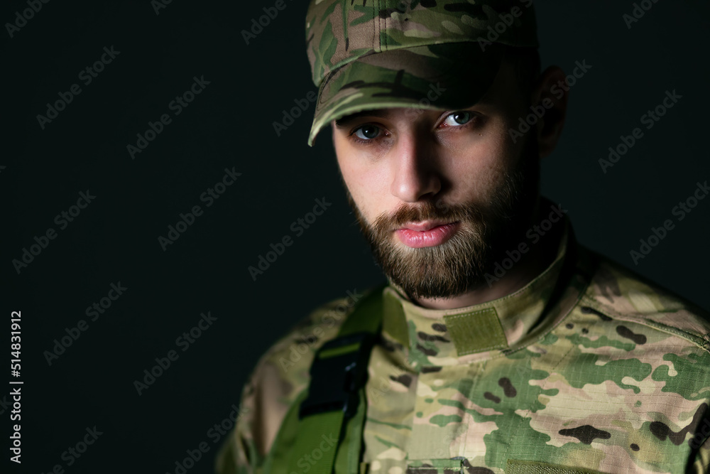 Close-up of a confident, serious soldier in camouflage standing Close-up of a confident, serious soldier in camouflage standing