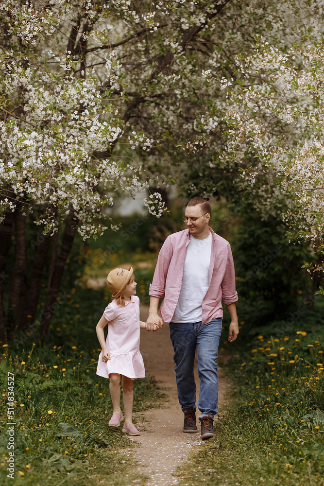 Father and little daughter are walking. Father and little daughter are walking.