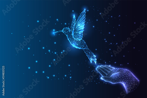 Futuristic concept of dream, hope, freedom, inspiration with hand and flying bird hummingbird 