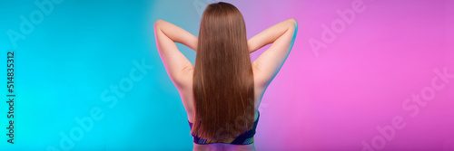 Sporty woman with long hair in fitness sportswear back view. Female fitness portrait isolated on neon multicolor background.