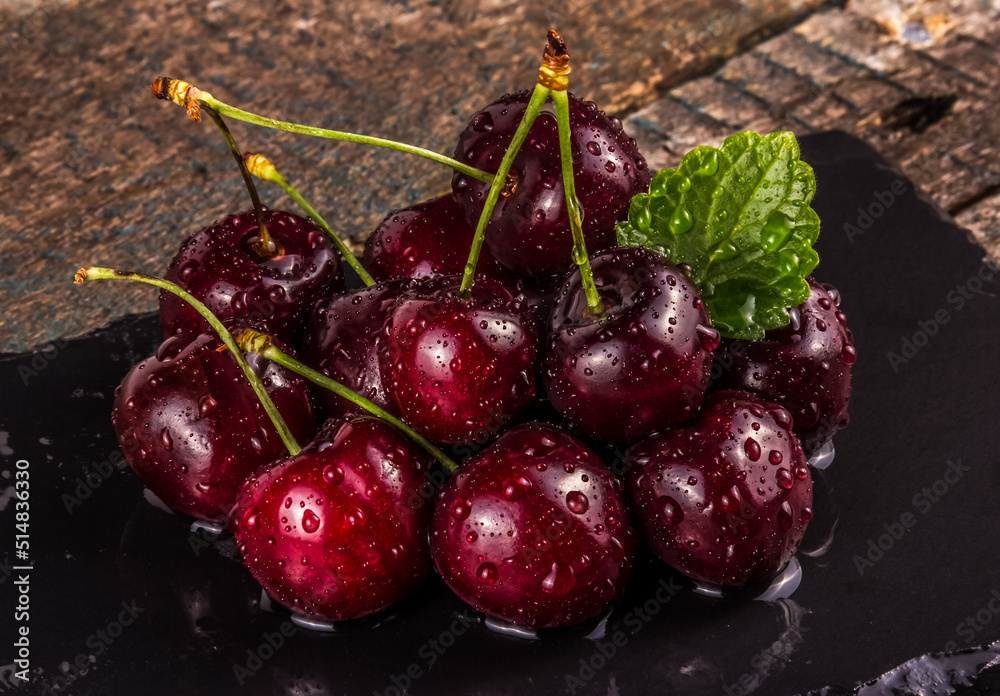 Red juicy cherry on a dark background