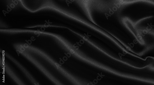 Smooth elegant black silk or satin texture as abstract background. Luxurious background design