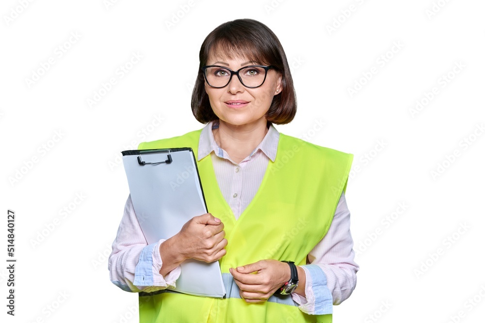 Woman in safety vest with clipboard looking at camera, white isolated background Woman in safety vest with clipboard looking at camera, white isolated background