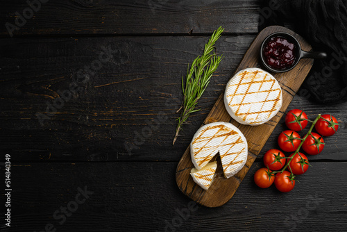 Homemade Baked Camembert cheese on black wooden table background, top view flat lay, with copy space for text
