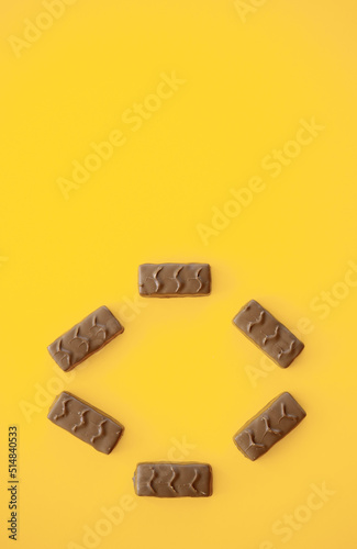 Chocolate candy bar on yellow background