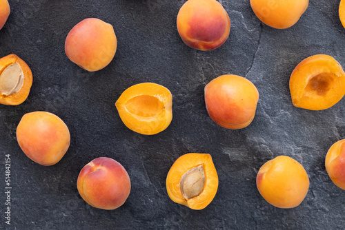 Delicious ripe sweet apricots on dark background, top view. Space for text