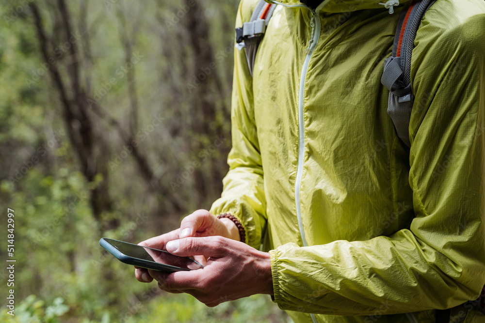 The phone is held in the hands of a person shot close-up, typing text on a smartphone, thumb on a cell phone screen. The phone is held in the hands of a person shot close-up, typing text on a smartphone, thumb on a cell phone screen.