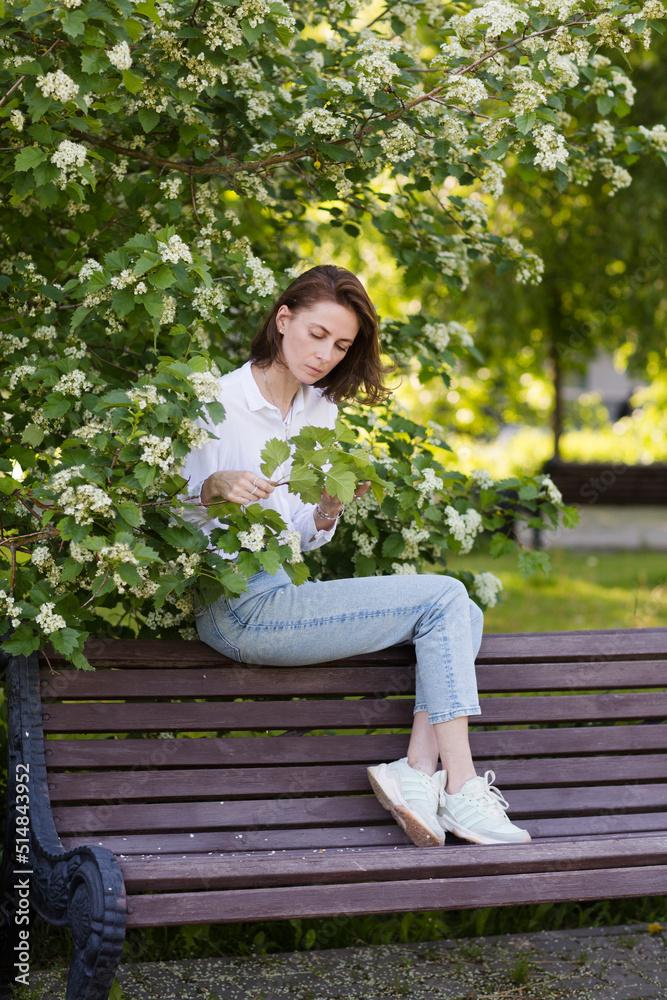 middle aged woman relaxed outdoors. copy space. Slow life. Enjoying the little things. spends time in nature in summer